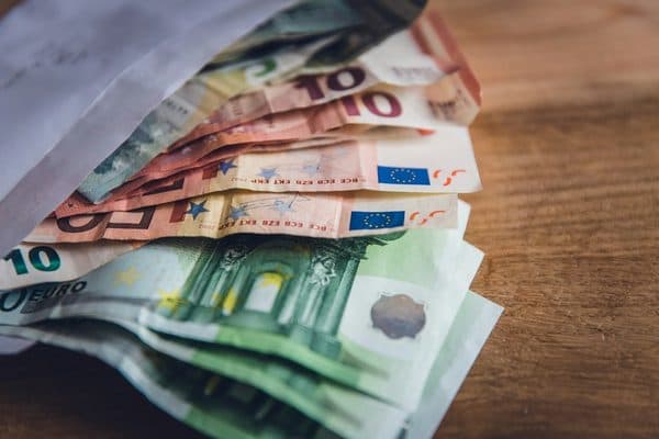 Euro banknotes tucked in an envelope