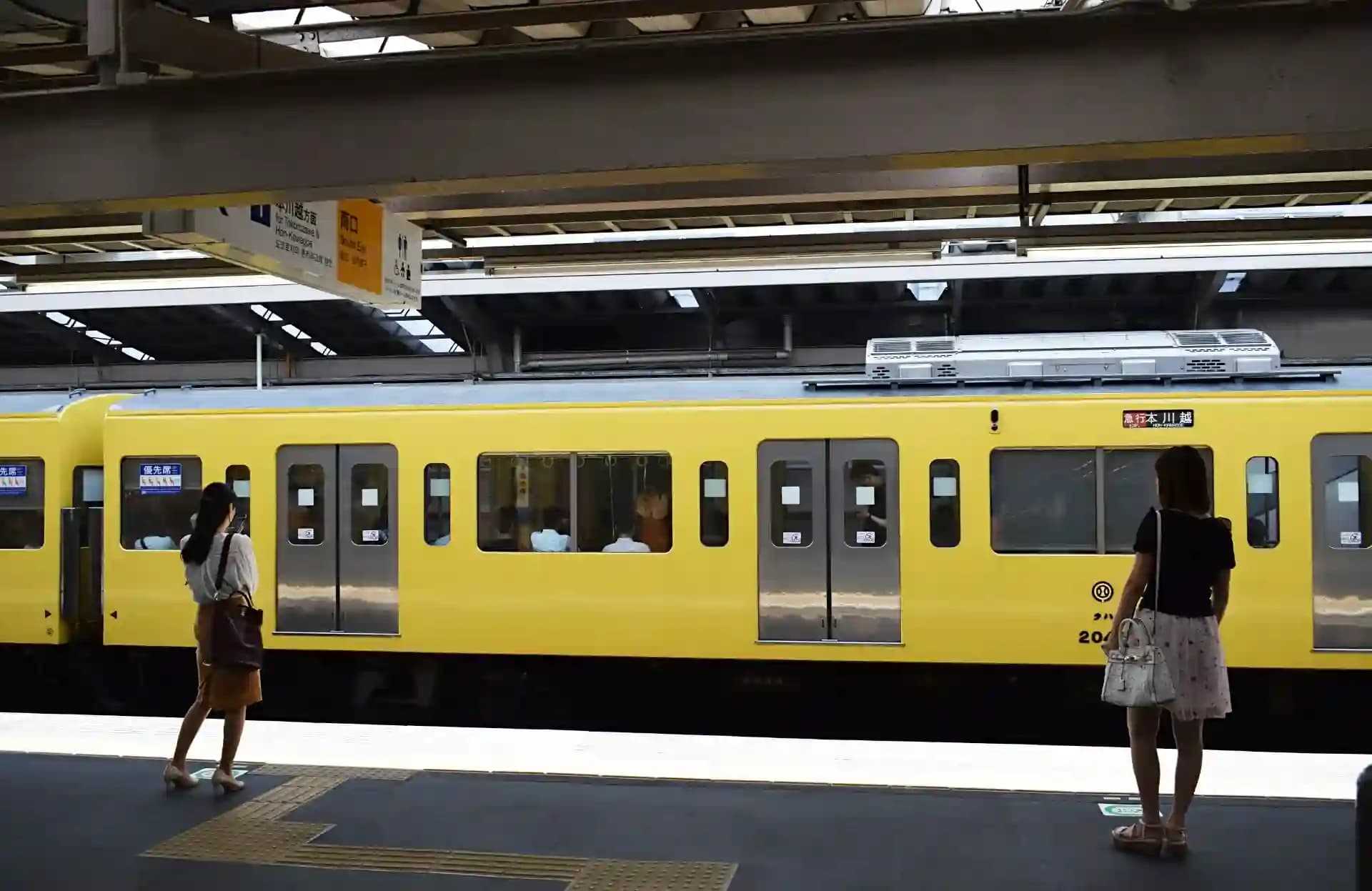 Tokyo metro platform with women-only carriage signage clearly marked