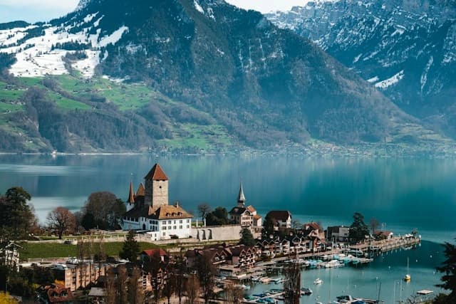 Spiez Castle on its promontory with the bay and vineyard
