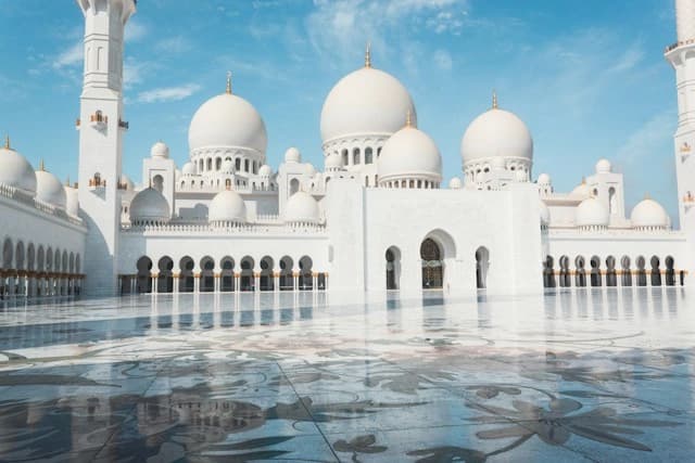 White marble domes and the reflecting pool of Sheikh Zayed Grand Mosque