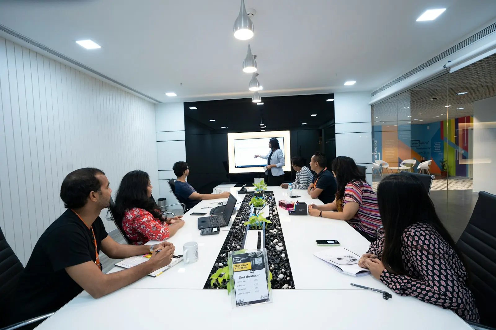 A team reviewing travel spend together on a presentation screen