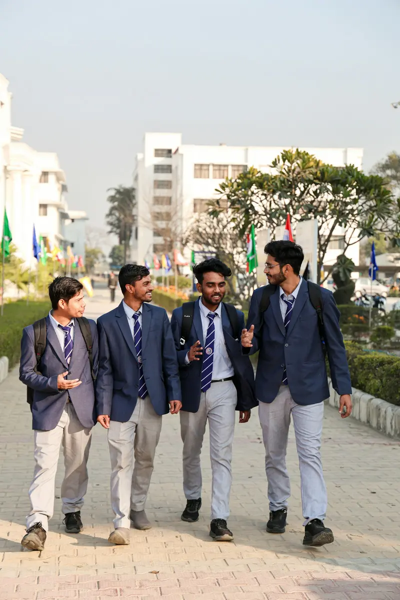 A student delegation in blazers walking across campus
